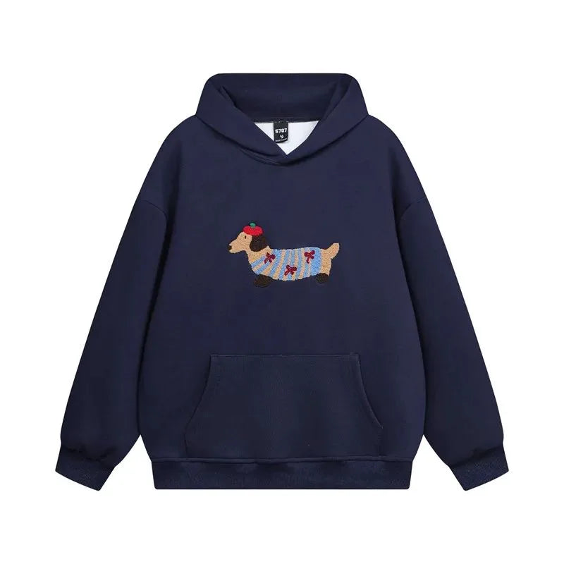 Navy hoodie laid flat, front view, highlighting the dachshund patch against the dark fabric