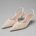 Pair of ivory embroidered mesh kitten heel slingbacks with pointed toe, floral beaded detail and slim strap