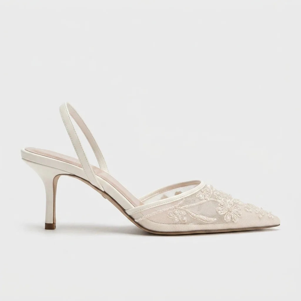 Studio side profile of an ivory mesh pointed toe kitten heel with beaded floral embroidery and slingback strap