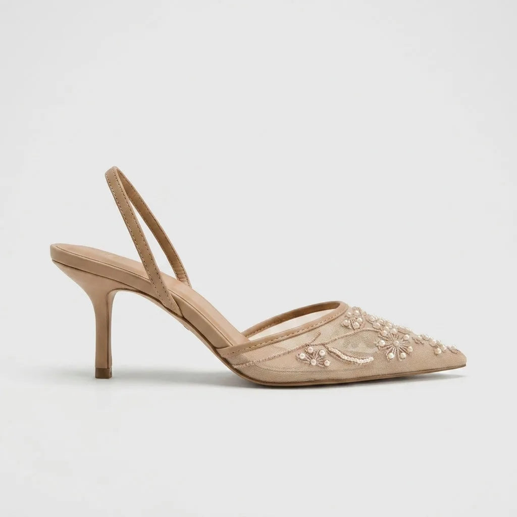 Studio side profile of a beige mesh pointed toe kitten heel with pearl floral embroidery and slingback strap