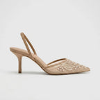 Studio side profile of a beige mesh pointed toe kitten heel with pearl floral embroidery and slingback strap