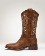 Side profile of brown cowboy boot highlighting the pointed toe, stacked block heel and embroidered shaft detailing