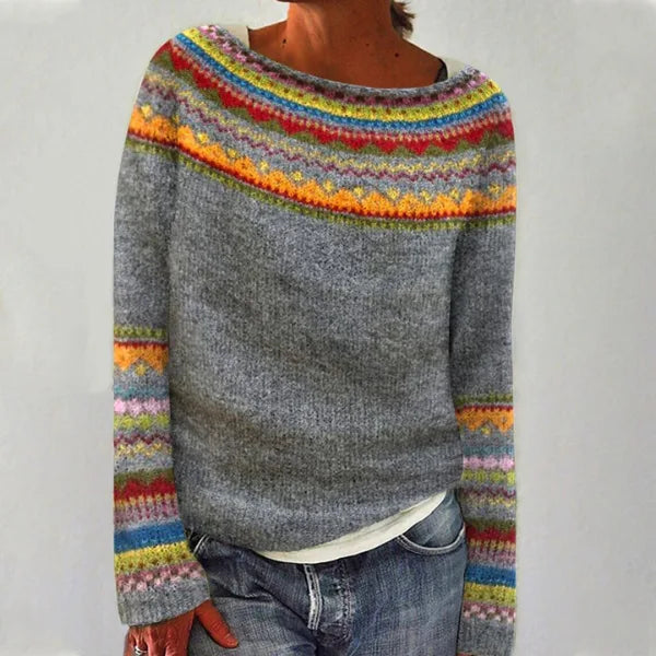 Grey Fair Isle jumper with a multicoloured rainbow-striped yoke and matching cuff trim, styled with denim