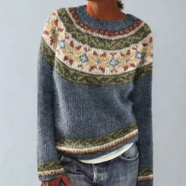 Blue Fair Isle jumper with a cream, olive and rust patterned yoke, paired with a white layering top and jeans