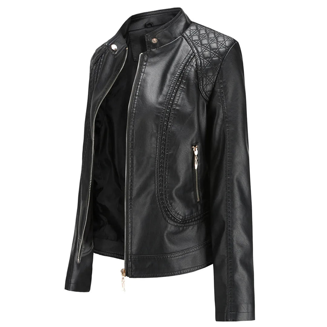 Side angled view of a black faux leather jacket showing the quilted shoulder panel, zip pocket and fitted silhouette