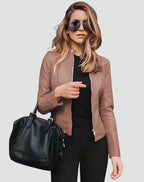 Close-up front view of the navy jacket showing the zip pockets and tailored waist seams