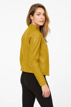 Front view of the jacket in mustard yellow, zip open, worn with a black top