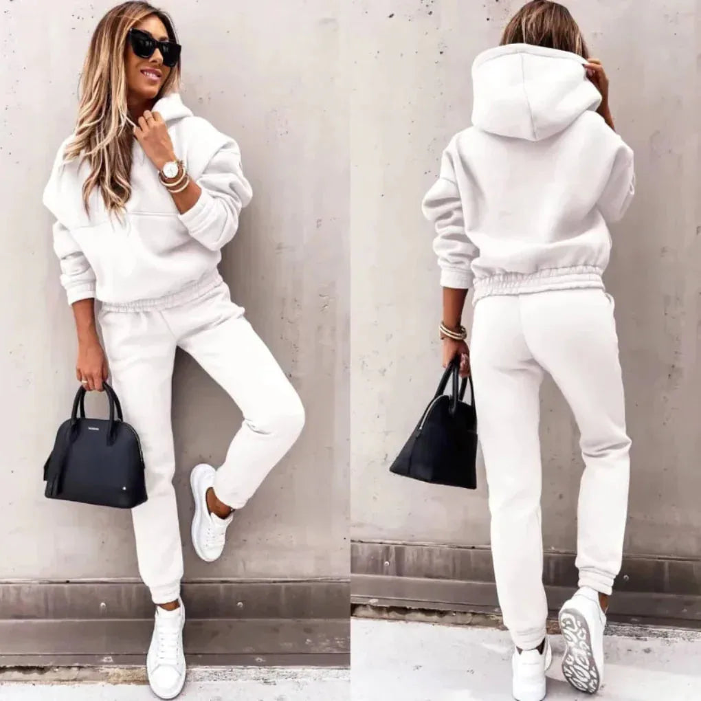 Front and back view of a white fleece tracksuit with stand-up hood and ribbed ankle cuffs on the joggers