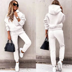 Front and back view of a white fleece tracksuit with stand-up hood and ribbed ankle cuffs on the joggers