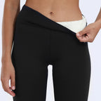 Side view of the black waistband folded down to reveal the plush cream fleece lining underneath