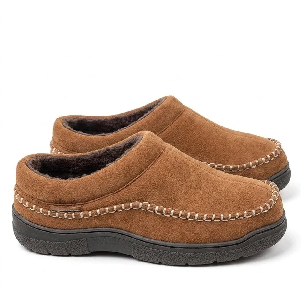 Side-by-side pair of light brown suede clog slippers with stitched trim and dark fleece lining