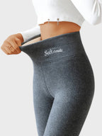 Side view of dark grey thermal leggings with high waistband and embroidered Soft.clouds label
