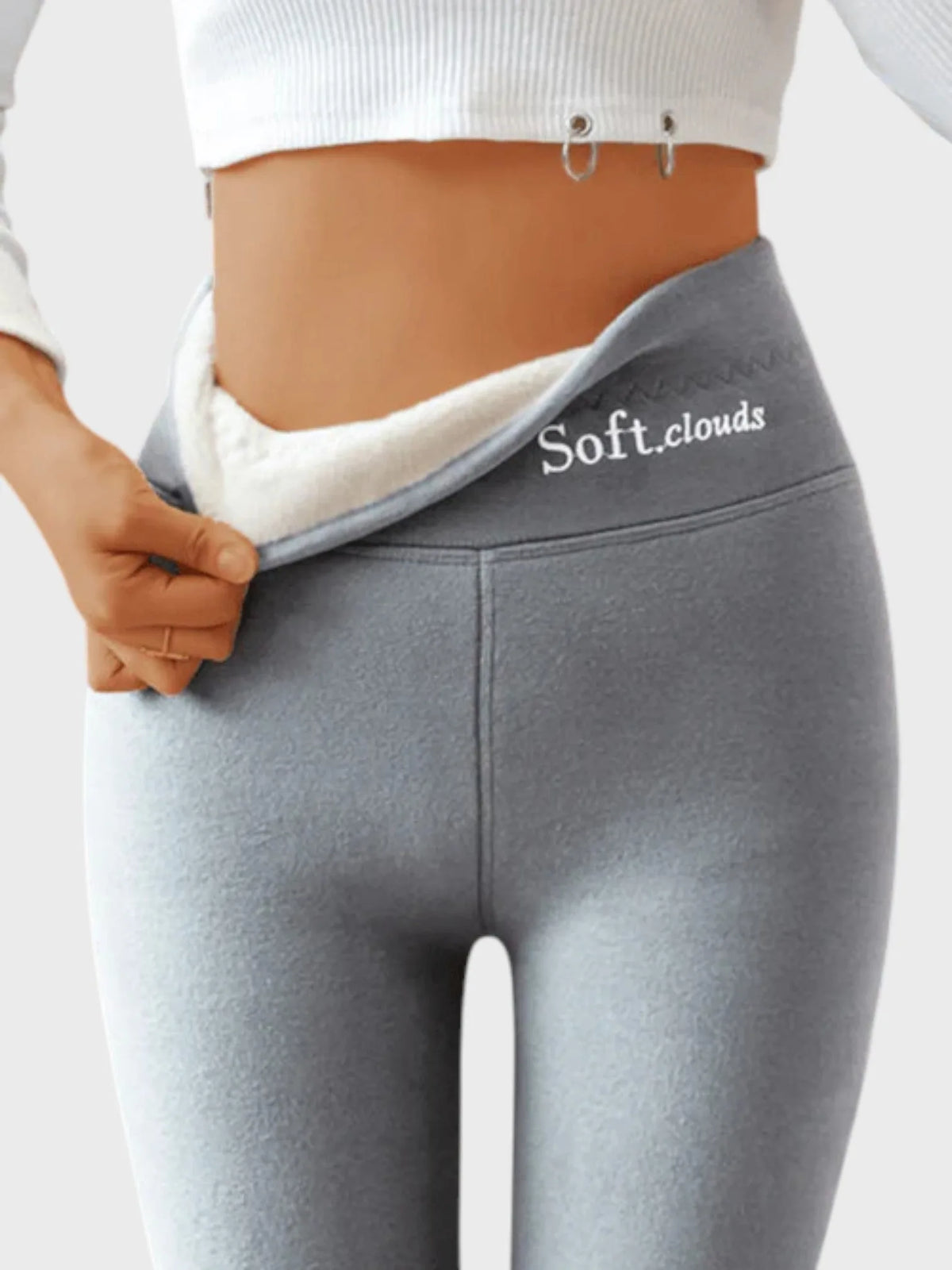 Grey thermal leggings pulled open at waist revealing thick white fleece lining and flat seam stitching