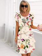 Cream tiered midi dress with multicolour floral print and ruffled layered skirt, round neck short sleeves
