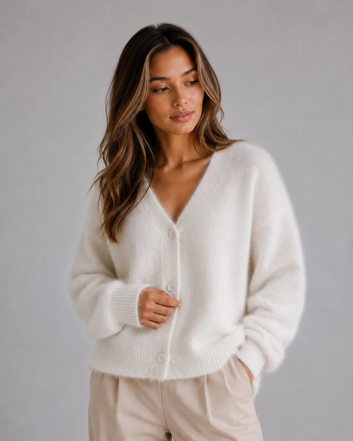 Woman wearing the fluffy knit cardigan in white, showing the soft brushed texture and button-front design