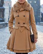 Camel wool-blend skater coat with a soft light brown faux fur collar, double-breasted buttons and a tied waist belt, worn outdoors