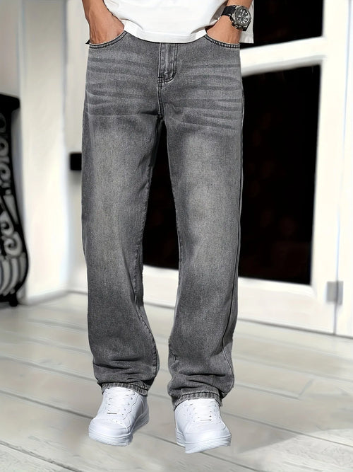 Front view of grey denim jeans on model with hands in pockets, showing regular fit and washed finish