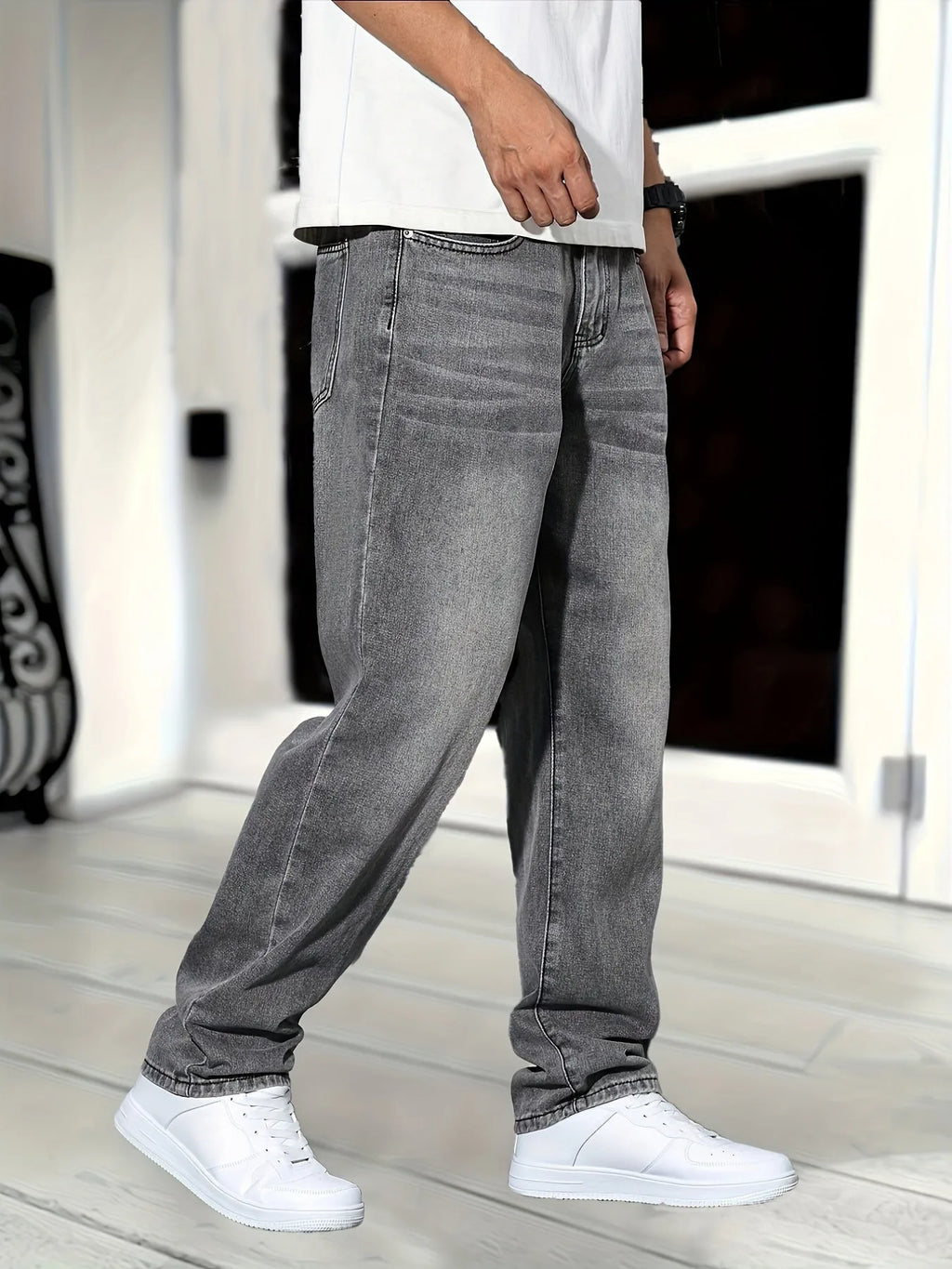 Three-quarter side view of grey jeans showing front pocket detail and leg drape while walking