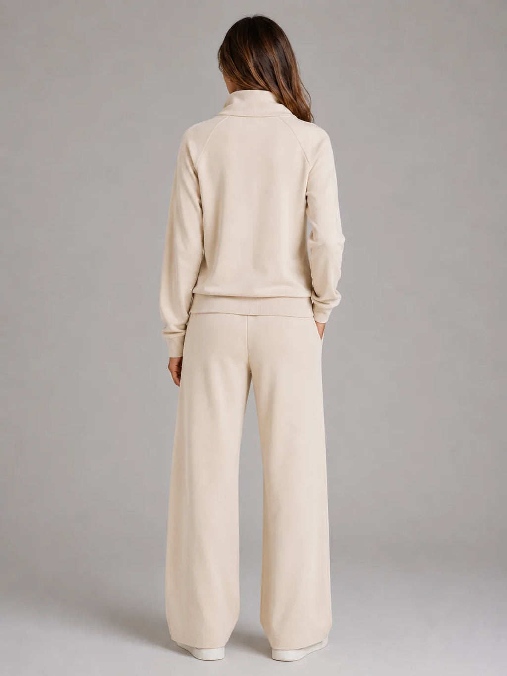 Back view of the cream half zip lounge set, showing the raglan sleeves and relaxed wide leg trouser fit