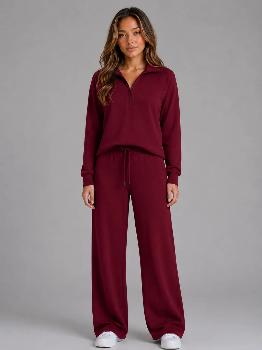 Front view of the loungewear set in burgundy, showing the half zip jumper and matching wide leg trousers