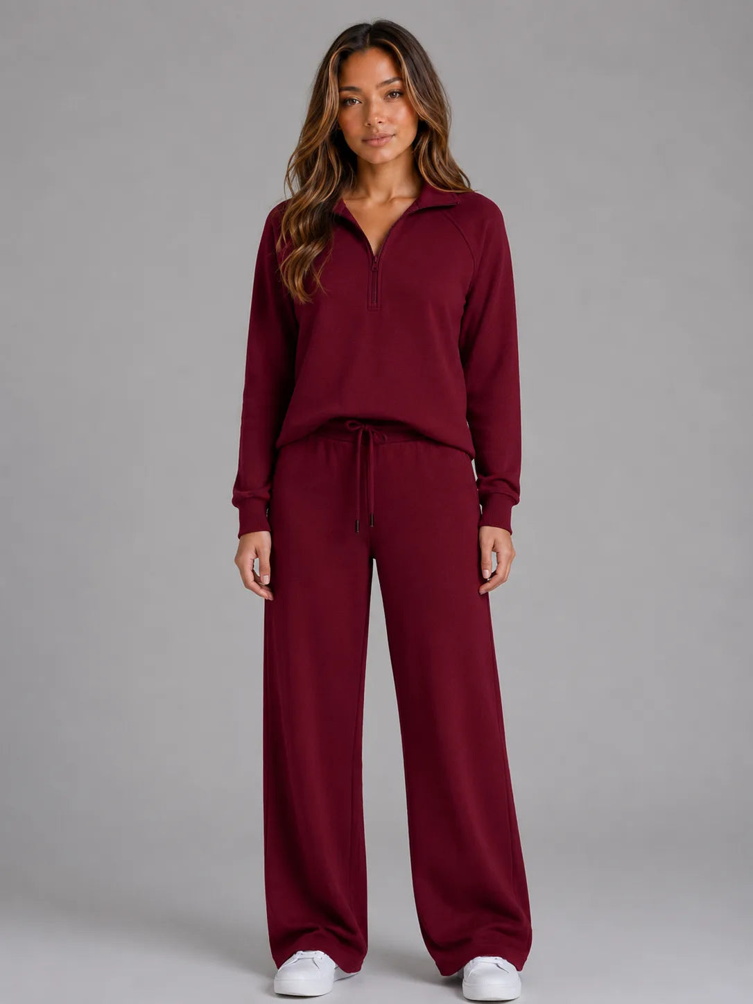 Front view of the loungewear set in burgundy, showing the half zip jumper and matching wide leg trousers