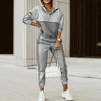 Grey half-zip tracksuit with black and white checked panel across the chest and matching side stripe on the joggers