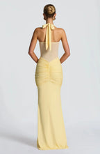 Back view of the yellow dress showing the halter tie fastening and ruched gathered skirt panel