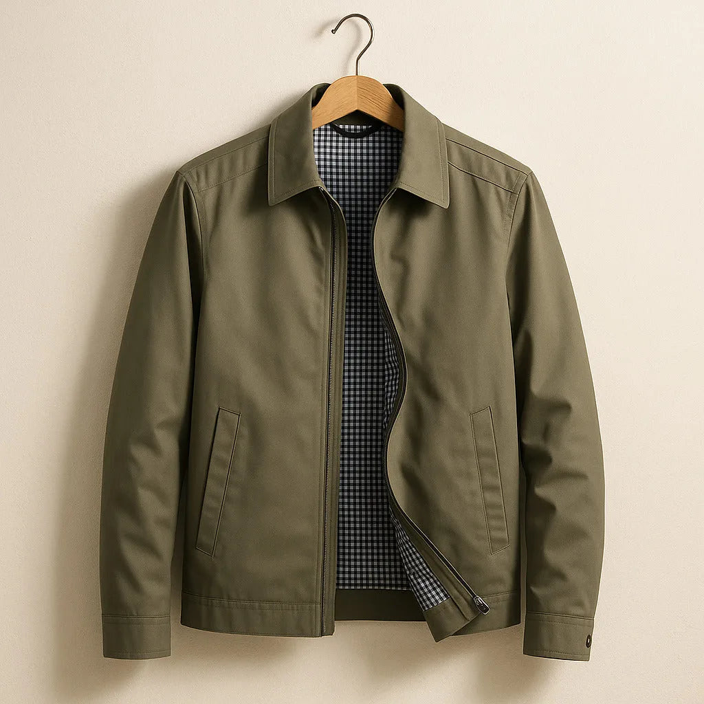 Olive green harrington jacket on wooden hanger, point collar and welt side pockets visible