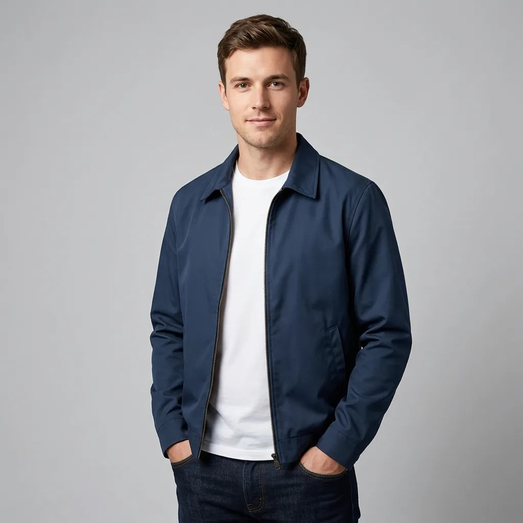 Man wearing navy blue harrington jacket zipped up over a white t-shirt, front view