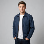 Man wearing navy blue harrington jacket zipped up over a white t-shirt, front view