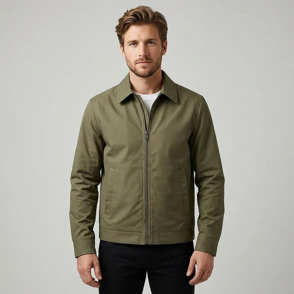 Man wearing olive green harrington jacket zipped up over a white t-shirt, front view