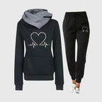 Black hoodie with white heartbeat heart print and soft grey hood lining, shown with matching black joggers