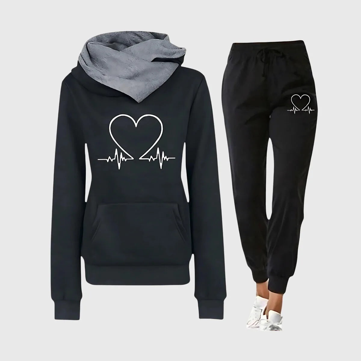 Black hoodie with white heartbeat heart print and soft grey hood lining, shown with matching black joggers