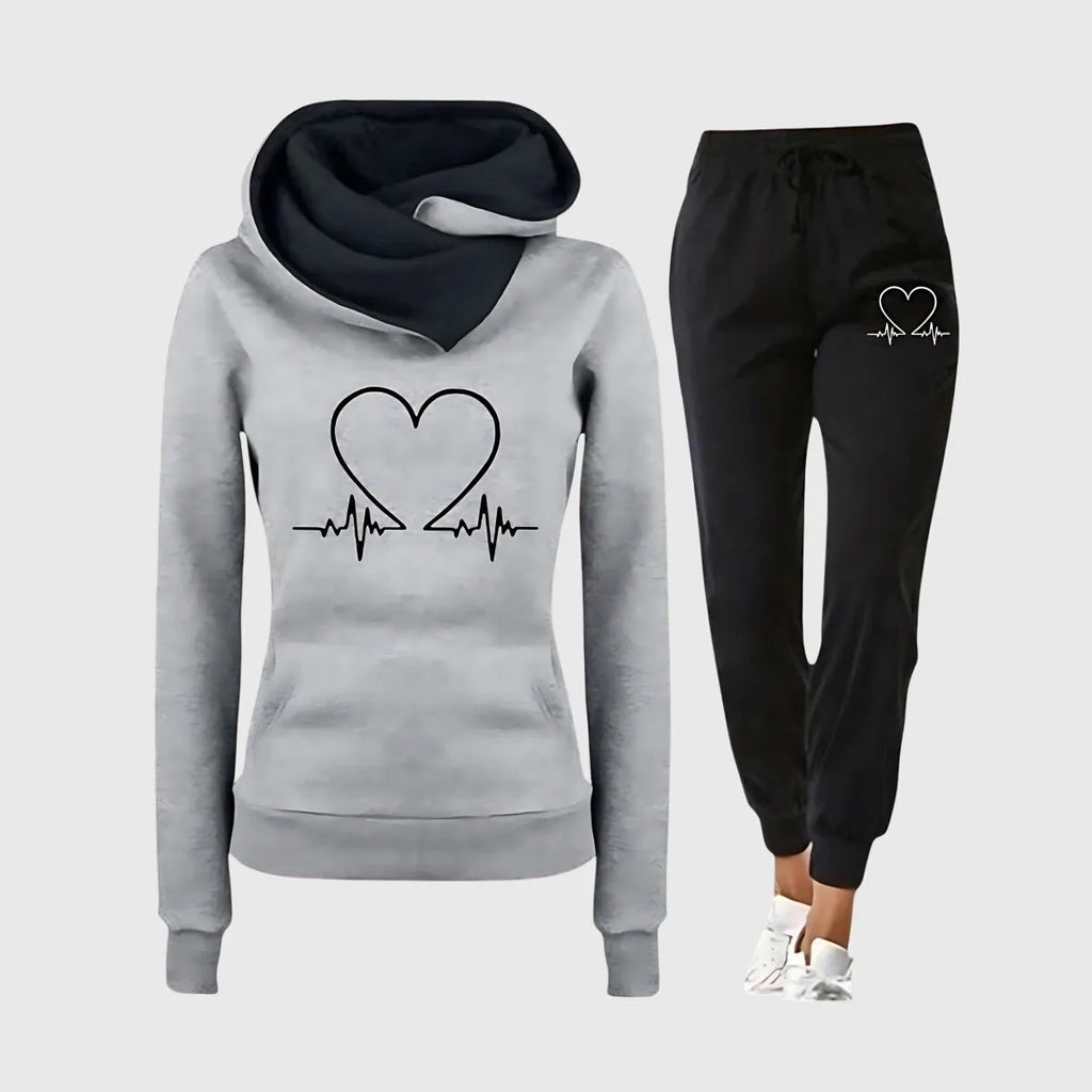 Grey marl hoodie with dark hood lining and heartbeat heart design, matched with black joggers and white trainers