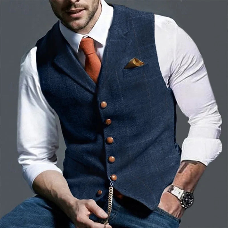 Man in white shirt and orange tie wearing a navy herringbone waistcoat with wooden buttons, front view