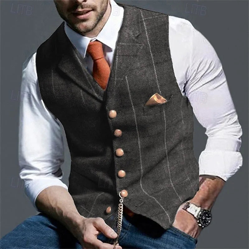Close-up of a dark grey pinstripe waistcoat worn over a white shirt with orange tie and gold pocket square