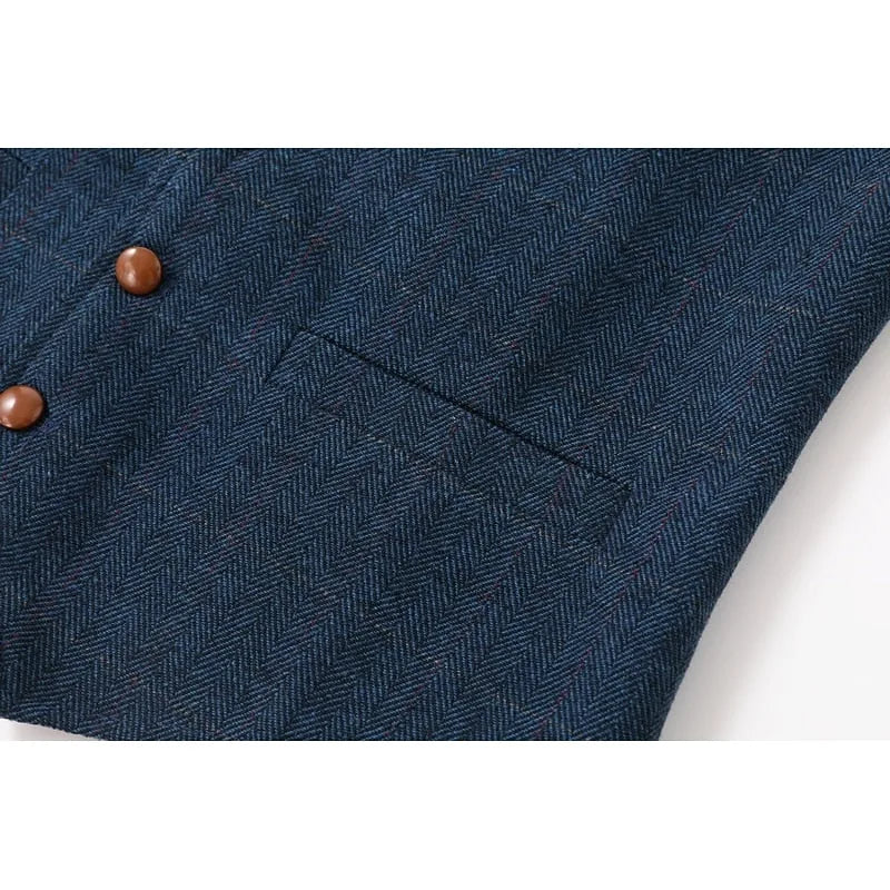 Detail view of the front welt pocket and button placement on the navy waistcoat