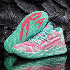 Mint green and pink high-top basketball shoe paired with matching coral drip-pattern outsole, shown against dark rock