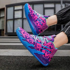 On-foot shot of pink, purple and blue leopard-print high-top basketball shoes with blue swirl sole, worn with cropped trousers
