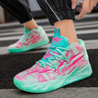 On-foot side view of mint green high-top basketball shoe with pink graffiti print, worn walking on pavement