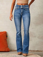 Front view of high-waisted flared blue denim jeans with double-button fastening, worn with a beige crop top