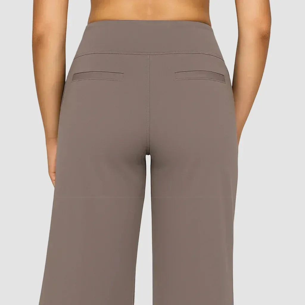 Back view of the taupe trousers highlighting the fitted waistband and twin faux welt pockets