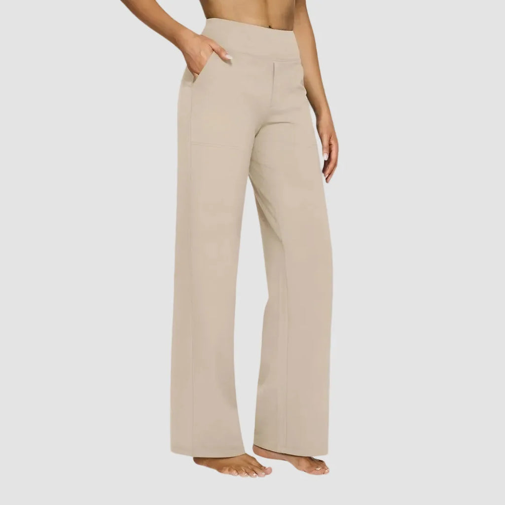 Side view of the same trousers in charcoal grey with hand resting in the front pocket