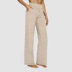 Side view of the same trousers in charcoal grey with hand resting in the front pocket