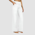 Side view of the wide-leg trousers in beige showing the high waist and relaxed leg