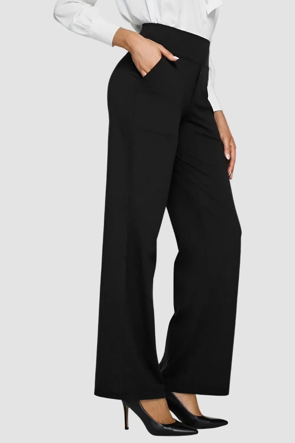 Side view of the trousers in black showing the smooth stretch fabric and wide leg
