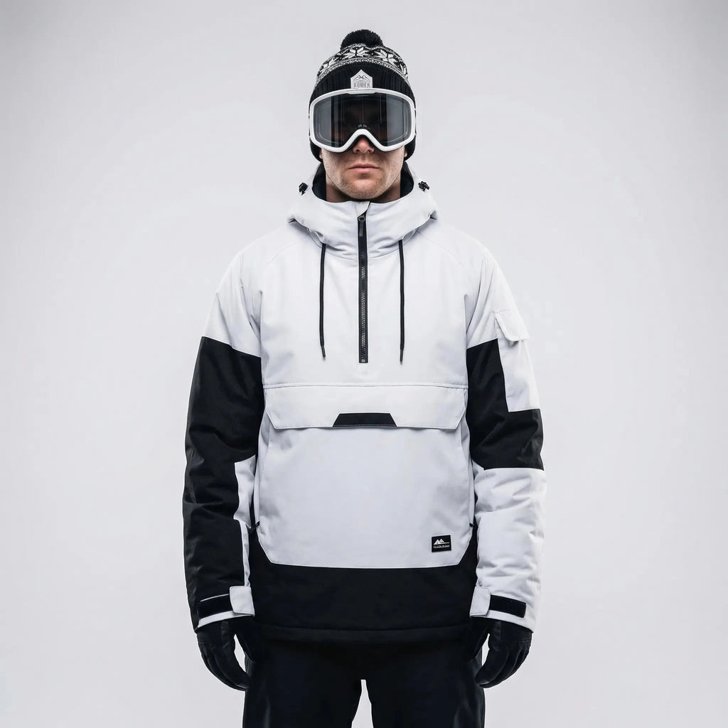 Front view of the white and black anorak styled with a bobble hat and ski goggles, hood down