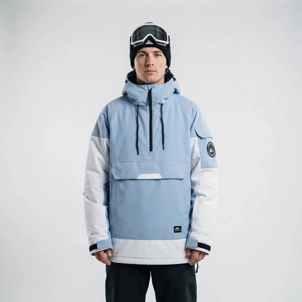 Model wearing the anorak in dusty blue and white colourblock with hood up and goggles on