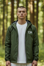 Close-up front view of the khaki green hooded jacket showing the zip, hood and chest logo detail.