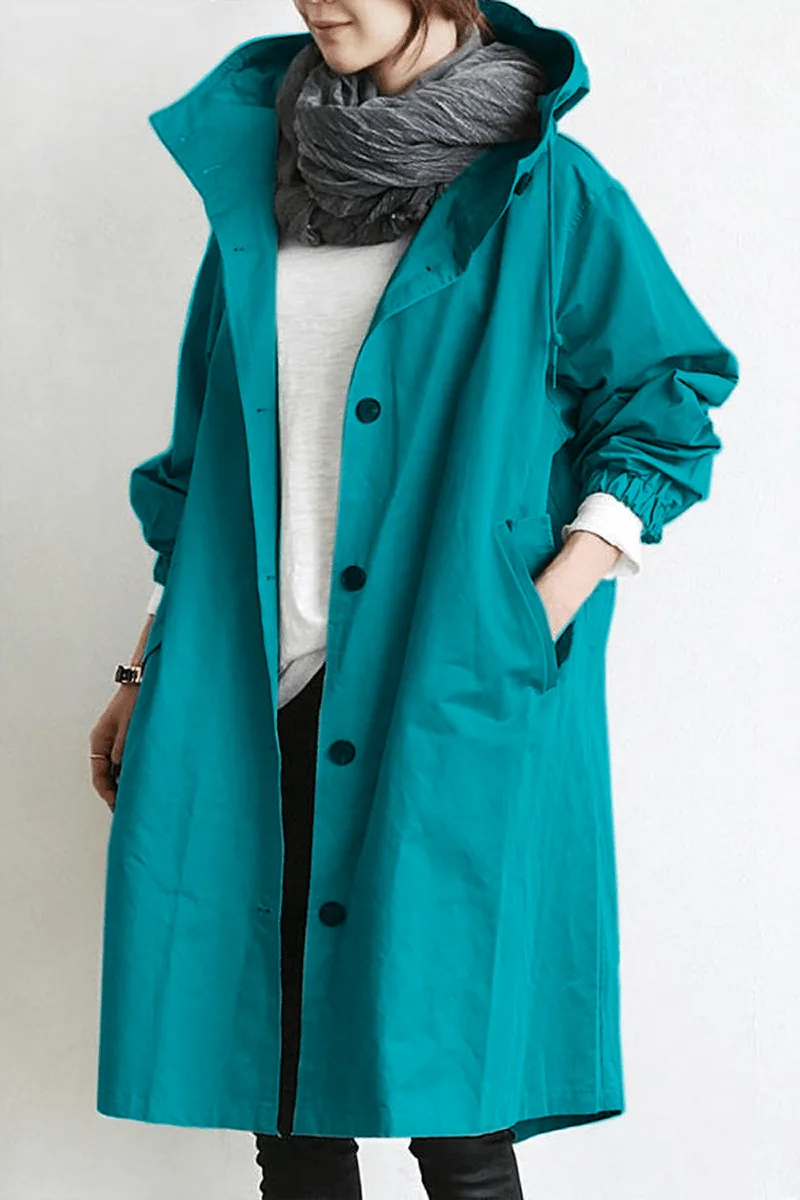 Turquoise hooded trench coat worn open, showing the front button fastening and side pockets